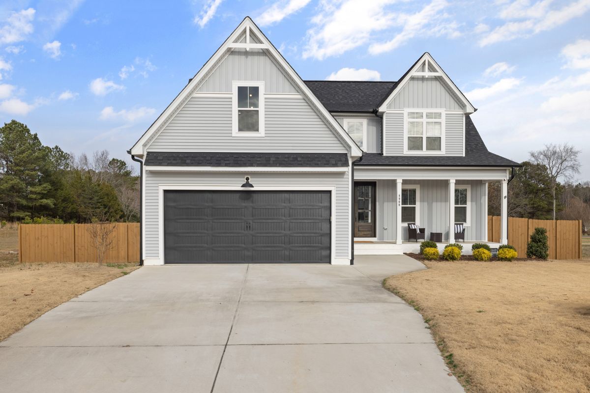 Modern grey home with a dark double garage door in Ottawa