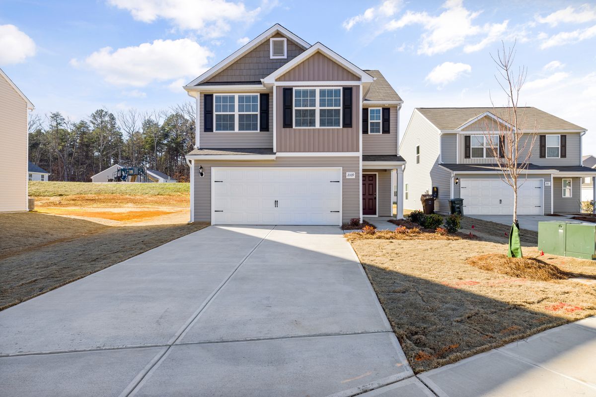 New-build home with a white double garage door in a Barrhaven subdivision, Ottawa